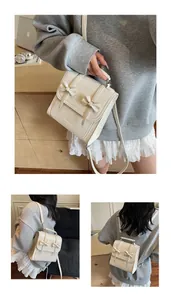 Lifestyle view of a cream bow-knot backpack for college students in a cozy setting.