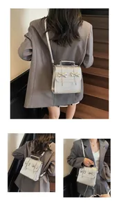 Silver metallic bow backpack shown from multiple angles on a model