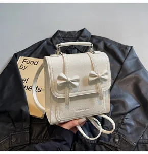 Stylish white backpack with bow detail and crinkled leather texture for daily commute