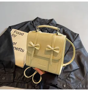 Detailed view of the yellow bow backpack featuring stylish textured synthetic leather