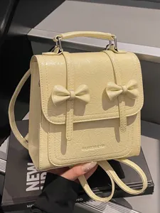 Stylish cream yellow mini backpack with elegant bowknot details for women's daily commute