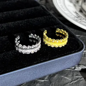 Primo piano di anelli in pizzo oro e argento con eleganti dettagli in metallo spazzolato