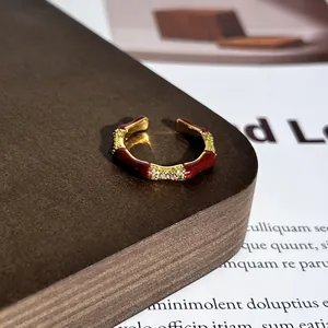 Detailansicht eines eleganten vergoldeten Emaille-Bambusrings mit eingelegten Steinen.