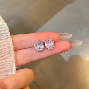 Close-up view of elegant lavender oval zircon stud earrings in a fine silver setting