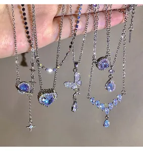 Detail view of multiple titanium steel necklaces with sparkling blue zircon pendants.