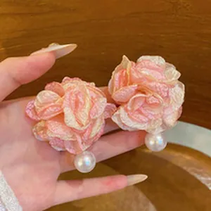 Exaggerated pink mesh flower earrings with pearl drop for summer beach vacation look