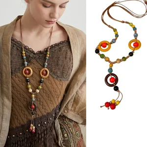 Close-up of bohemian ethnic style long necklace with ceramic beads and wooden rings