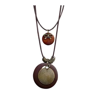 Vintage ethnic style long necklace featuring a wooden pendant and bronze metal spiral