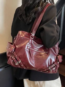 Stylish large burgundy textured tote bag with multi-pocket design and buckle detail
