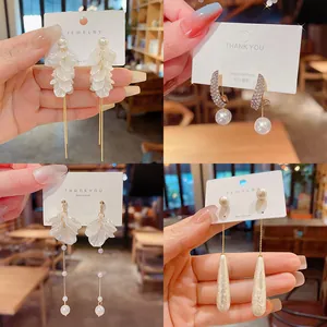 Close-up view of elegant S925 silver needle earrings with pearls and petal tassels