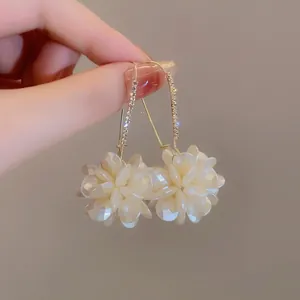 Detailed view of elegant flower petal earrings featuring sparkling rhinestone accents.