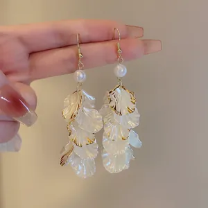 Elegant white petal tassel earrings featuring pearl accents and gold-rimmed edges