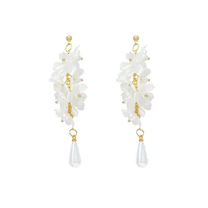 Elegant white flower petal dangling earrings with pearl teardrop and gold-tone finish.