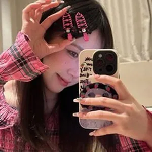Close-up of pink Y2K hair clips with rhinestones worn by a model in a mirror selfie