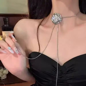 Elegant silver metal rose choker necklace with long cascading chain drop on model neck.