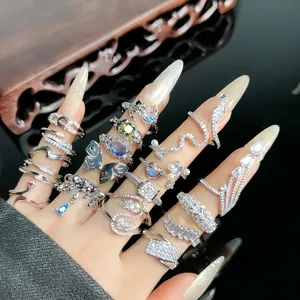Close-up of luxury pavé-set snake and butterfly rings with sparkling zircon details