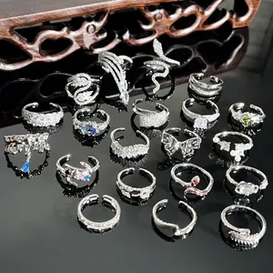Collection of elegant silver rings with micro-pave crystals and snake shapes for women.