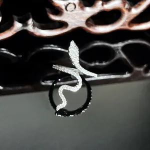 Detailed macro shot of a sparkling silver snake-shaped ring with micro-pave crystals