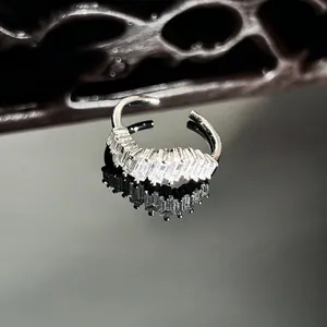 Detailed macro view of shimmering baguette-cut stones on a silver-toned open ring