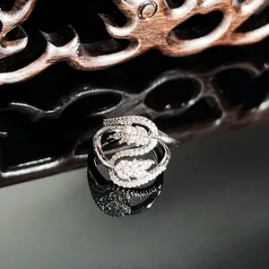 Macro detail of a luxury silver snake-shaped ring with full micro-pave inlaid diamonds