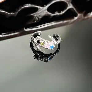 Macro detail of silver snake ring with colorful micro-inlaid sparkling crystals.