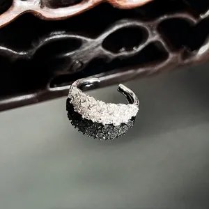 Close-up of an elegant silver ring with full pave cubic zirconia in a wave design