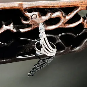 Close-up detail of an elegant silver snake-shaped ring with shimmering white stone pavé.