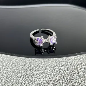 Vue détaillée d'une bague nœud en argent avec des cristaux violets étincelants