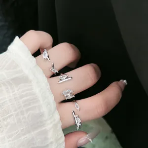 Close-up detail of elegant silver-colored open ring with marquise-cut cubic zirconia