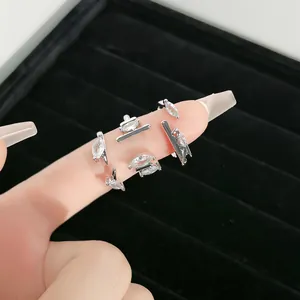 Macro detail view of a silver minimalist open ring featuring marquise cubic zirconia stones.