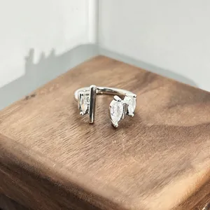 Detailed close-up showing marquise-cut zircon stones on a silver adjustable open ring