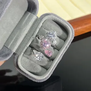 Elegant pear-shaped pink cubic zirconia and heart halo open rings in a velvet box detail