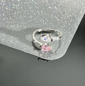 Close-up of a silver-toned open ring featuring pink and white pear-shaped cubic zirconia.