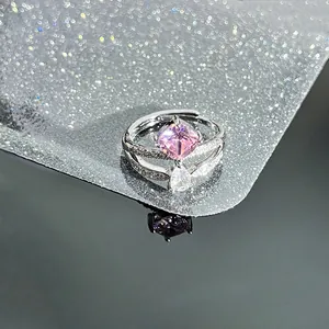 Macro detail of luxury pink square zircon and waterdrop stone on silver double band ring