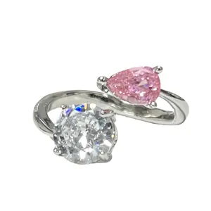 Elegant open ring featuring a pear-cut pink stone and round clear cubic zirconia.