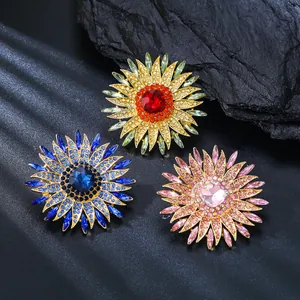 Close-up of crystal sunflower brooches in red, blue, and pink colors for banquet dress