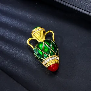 Detailed close-up of French vintage vase brooch with green enamel and sparkling crystals