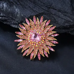 Detailed view of elegant pink crystal sunflower brooch on dark natural stone background