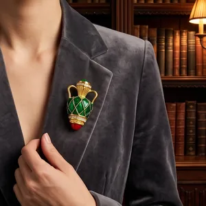 Vintage French vase brooch with green enamel and gold accents on grey blazer