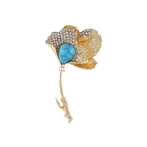 Elegant luxury gold ginkgo leaf brooch featuring turquoise and sparkling rhinestones