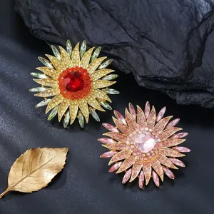 Elegant crystal sunflower brooch pins for banquet dresses in red and pink colors.