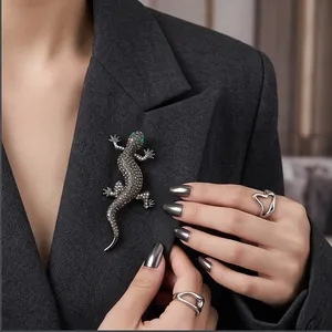 Elegant vintage lizard brooch encrusted with sparkling rhinestones on a dark blazer lapel