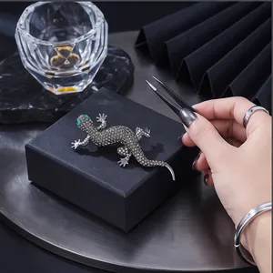 Vintage rhinestone lizard brooch on a black jewelry box for elegant suits and dresses