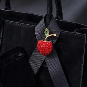 Exquisite red apple brooch with full rhinestone inlay on black ribbon and handbag