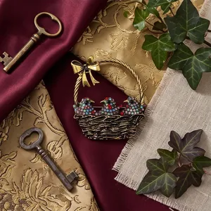 Vintage bronze basket brooch featuring colorful rhinestone birds and elegant ribbon