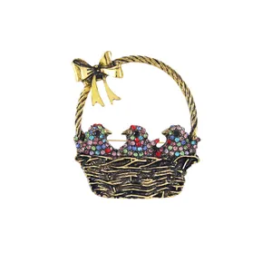 Vintage golden bird basket brooch with colorful rhinestones for clothes decoration.