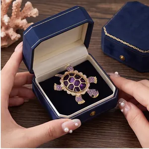 Elegant purple rhinestone turtle brooch in a blue velvet gift box