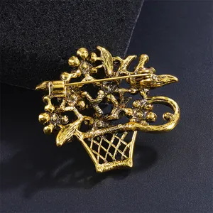 Detailed view of the back of a vintage gold flower basket brooch with pin mechanism.