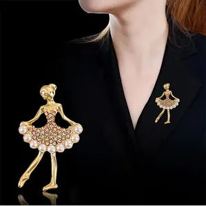 Detail shot of a golden ballerina brooch with pearls and crystals on a black blazer.