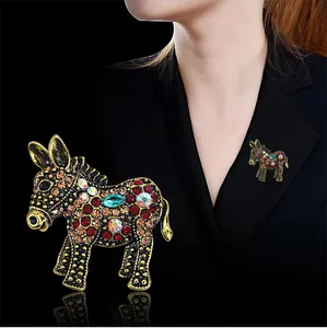 Exquisite vintage donkey brooch featuring colorful rhinestones pinned on a black blazer.
